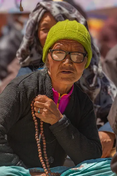 stock image Portrait of an old Buddhist women siting and chanting with religious beads at Leh, Ladakh on 23 May 2024.