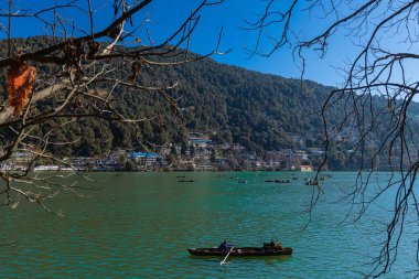 View of tourists enjoying boat ride in Naini lake at Nainital, India, a famous tourist destination. Clicked on 2 Jan 2022. clipart