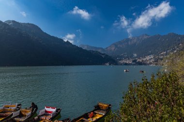 Boats tied at the banks of the famous Naini lake in Nainital, a preferred summer tourist in India. Clicked on 2 January 2022. clipart