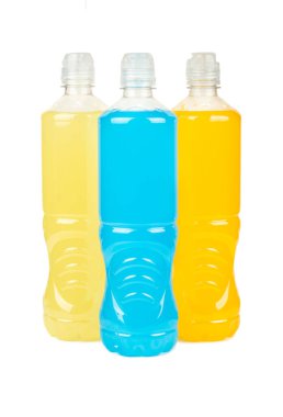 Three multi-colored plastic bottles with isotonic for sports isolated on white background.