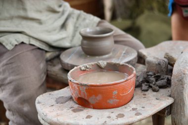 Ellerinde kil kap, çanak çömlek