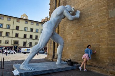 Florence, Italy - October 18, 2022: The monumental sculpture Mr. Arbitrium by Emanuele Giannelli, was temporary located at the wall of Basilica of San Lorenzo from September 2 to October 31, 2022.
