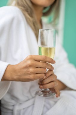 hand holding a glass goblet with a champagne drink, celebration and leisure activity