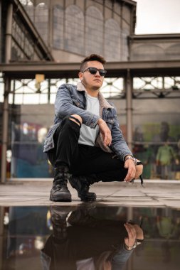 cool lifestyle of young latin man with short hair wear casual clothes and sunglasses, male model portrait, fashionable in the city
