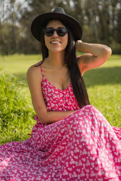 stock image beautiful sunny day with young latin woman enjoying nature, glamor model wearing patterned dress, sunglasses and hat, beauty and fashion