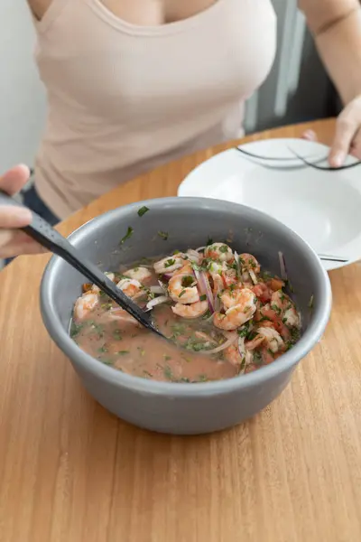 food preparation in the kitchen, healthy soup with seafood and vegetables, delicious shrimp ceviche, detail of textures of the traditional dish