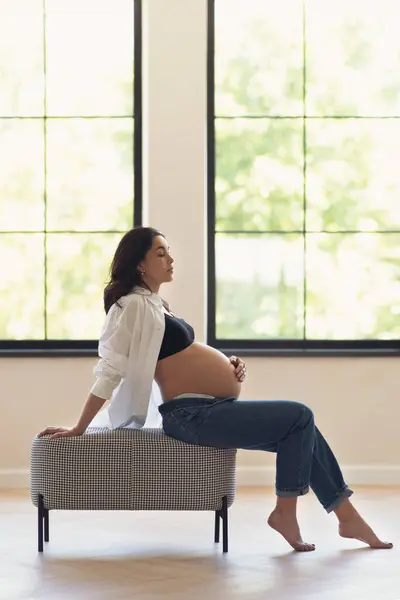 Μια Έγκυος Γυναίκα Κάθεται Ένα Παγκάκι Ένα Δωμάτιο Επιδεικνύοντας Μια Εικόνα Αρχείου
