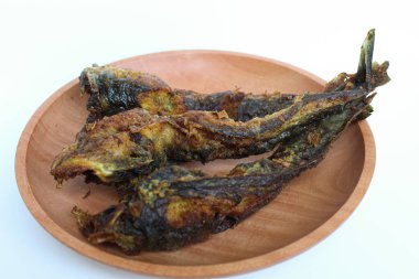 Fried catfish on a wooden plate, isolated on white background clipart