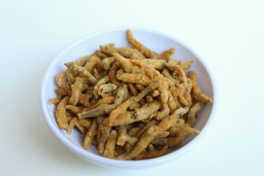 Teri çıtır çıtır, beyaz yem ya da bebek ançüez balığı ya da Endonezya 'da un ile kızartılmış teri nasi. Küçük beyaz bir kasede. Beyaz arkaplanda izole.