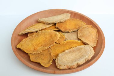 Sliced and dried rhizome of Curcuma zanthorrhiza, or temulawak, or Java ginger, or Javanese ginger, or Javanese turmeric. Isolated on white background clipart