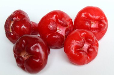 Small and red colored fruit of Syzygium aqueum. Also known as water cherry, watery rose apple, water apple, bell fruit, jambu air, or jamur kancing, isolated on white background clipart