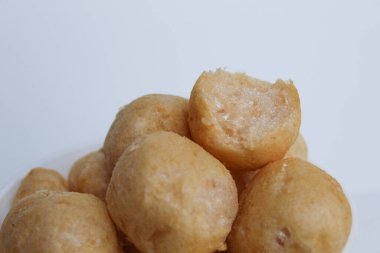 Bitten fish crackers in ball shape. isolated on white background