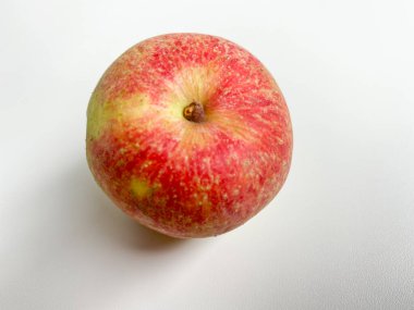 An apple, reddish color, view from top or flat lay, isolated on white background clipart