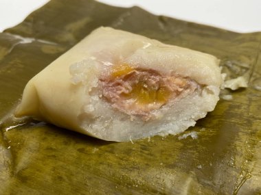 Nagasari or nogosari, traditional pudding with banana slice inside, wrapped in banana leaves. Snack from Indonesia clipart