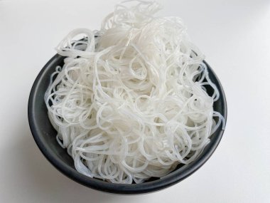 Rice noodle on black bowl, isolated on white background clipart