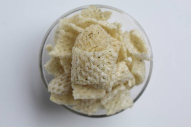 Ağ şeklinde krakerler, şeffaf cam kasede. beyaz arkaplanda izole edilmiş, düz ya da üst görünümde