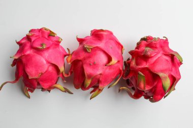 Red pitaya fruits. Three fresh dragon fruit, isolated on white background clipart