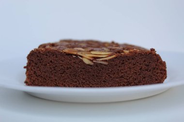 Badem soslu kek, beyaz arka planda izole edilmiş, kenar manzaralı.