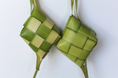 Ketupat wrap, woven young coconut leaves, before cooked. Isolated on white background clipart