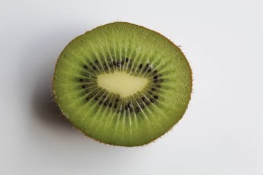 Diagonal cut of kiwi fruit, isolated on white background clipart