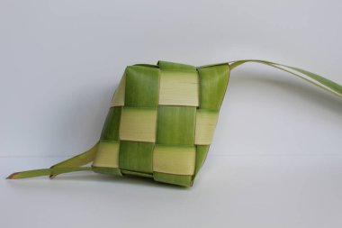 Ketupat wrap, woven young coconut leaves, before cooked. Isolated on white background clipart