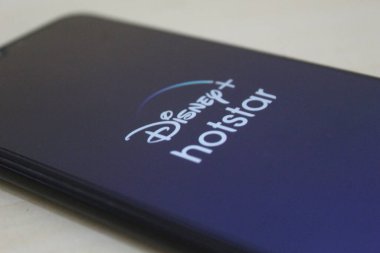 Disney Plus Hotstar app logo display on a smartphone. Disney is a global provider of streaming movies and TV series. In November 27th 2022 on Semarang, Indonesia clipart