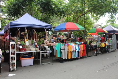 Street vendor sell bags and clothes on the road. In April 12th 2022 on Semarang, Indonesia clipart