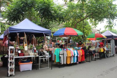 Street vendor sell bags and clothes on the road. In April 12th 2022 on Semarang, Indonesia clipart