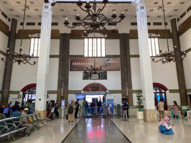 Semarang, Indonesia - December 24th 2023: Inside waiting area or Departure Lounge at Semarang Tawang Train Station. Dutch colonial style architecture clipart