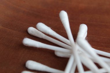 New white cotton buds or cotton swab or Q-tips, on wooden background, top view clipart