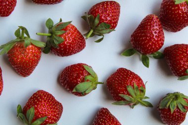 Beyaz arka planda izole edilmiş taze çilekler serpin.