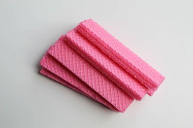 Beyaz arka planda izole edilmiş pembe uzun gofretler.