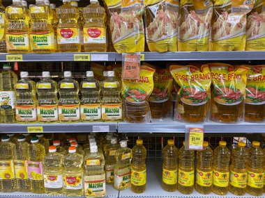 Semarang, Indonesia - October 7th 2023: : Various cooking oil brands at Indonesia, displayed on supermarket shelf clipart