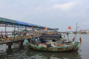 Fisherman boat from wood, floating on the sea. Jepara, Indonesia, April 29th 2023 clipart