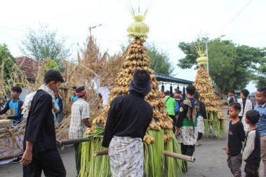 Gunungan lepet, is a tradition to arrange local food or rice cake in pyramid form, usually on a festival. Jepara, Indonesia, April 29th 2023 clipart