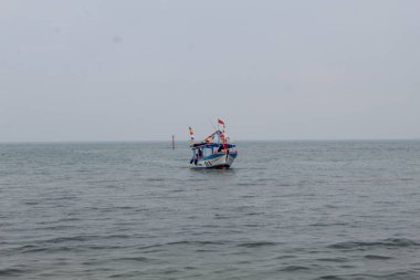 Fisherman boat from wood, sailing in the middle of the sea, on Java sea. Jepara, Indonesia, April 29th 2023 clipart