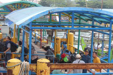 People on que to get in the ship at Kartini Harbor. Jepara, Indonesia, April 29th 2023 clipart