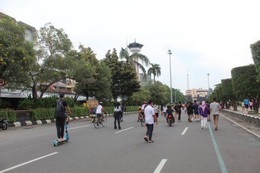 Semarang citizen enjoy car free day, by doing exercises on the street. Semarang, Indonesia, December 25th 2022 clipart