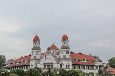 Lawang Sewu, iconic ancient building and tourist attraction at Semarang City. Cloudy sky background. Semarang, Indonesia, December 25th 2022 clipart