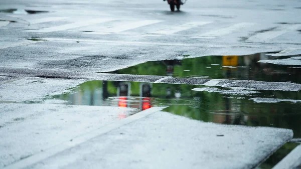 stock image The little water pool on the road  in the city after the rain