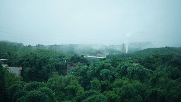 The beautiful countryside view from the runny train on the south of the China in the rainy day