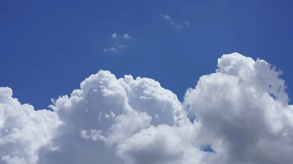 The beautiful sky view with the white clouds and blue sky as background in summer