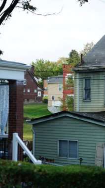 Daireler sonbaharda sıcacık güneş ışığı ve renkli ağaçlarla görünüyor.