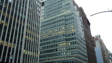 Arka planda gökdelenler ve eski binalar olan New York şehri manzarası.