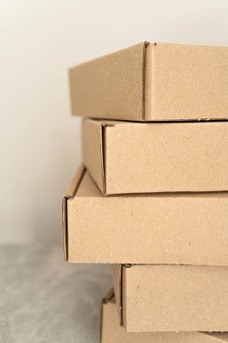 Tarafsız bir arkaplana karşı dizilmiş kraft karton kutuların detaylı yakın çekimi. Çevre dostu ambalaj, hediye paketleme, nakliye ve depolama çözümleri için ideal. 