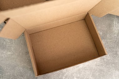 Top view of an open kraft cardboard box with an empty interior. Ideal for showcasing packaging concepts, sustainable storage, and eco-friendly design themes. clipart