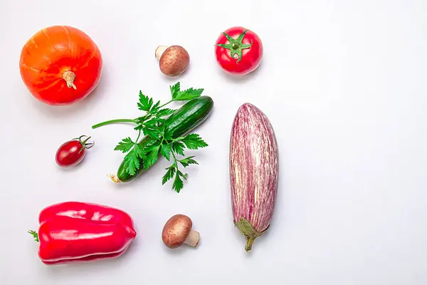 stock image Creative layout of zucchini, bell peppers, sherry tomatoes, tomatoes, cucumbers, parsley branch and mushrooms on a white background. Food concept. Healthy food. View from above. Copy space.