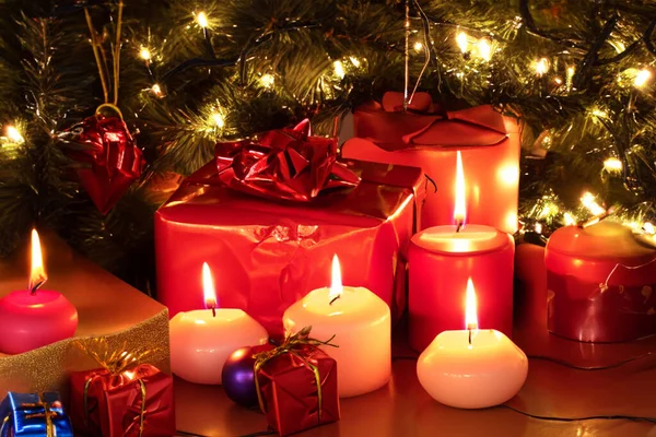 Christmas decoration with gift boxes, red candles, Christmas tree and colorful balls. Christmas.