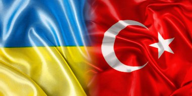 Ukrayna ve Türkiye 'nin ulusal bayrakları bir araya getirilip yan yana çırpınan bir pamuk zemin üzerine konuyor.