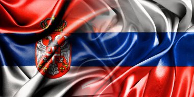 Rusya ve Sırbistan 'ın ulusal bayrakları bir araya getirilerek yan yana çırpınan bir pamuk zemin üzerinde yerleştirildi.